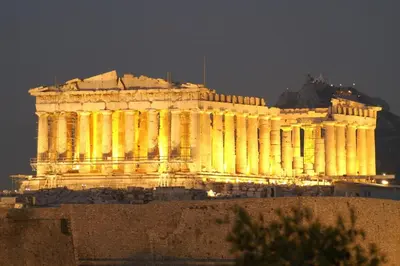 a building lit up at night with yellow lights at Cozy studio near Victoria metro station in Athens