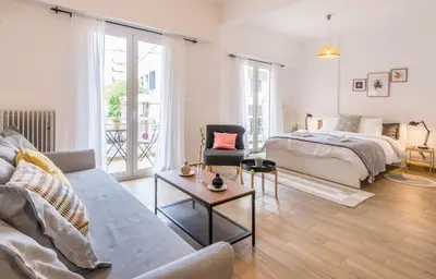 a living room with a bed and a couch at Wide Comfy Studio Apartment Centrally Located In Thissio in Athens