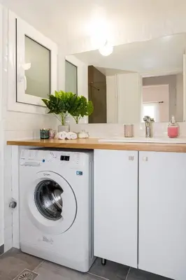 a kitchen with a washing machine under a counter at Wide Comfy Studio Apartment Centrally Located In Thissio in Athens