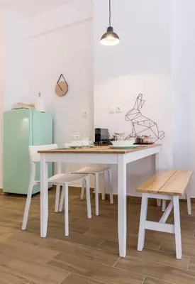 a kitchen with a table and chairs and a refrigerator at Wide Comfy Studio Apartment Centrally Located In Thissio in Athens