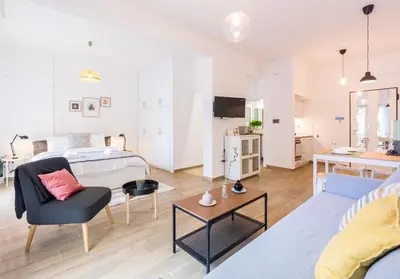 a living room with a bed and a couch at Wide Comfy Studio Apartment Centrally Located In Thissio in Athens