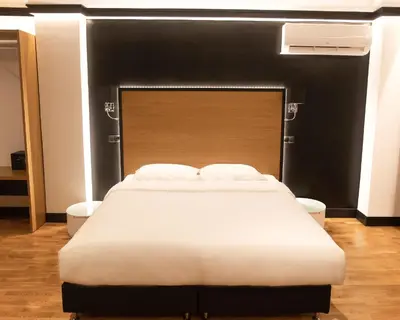 a bedroom with a large bed with a black headboard at Andromeda Downtown Residence in Athens