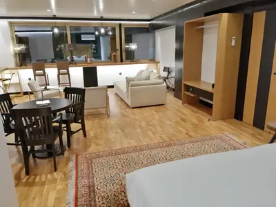 a living room with a couch and a table and chairs at Andromeda Downtown Residence in Athens