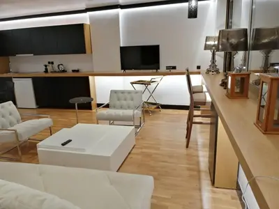 a living room with a couch and a table at Andromeda Downtown Residence in Athens