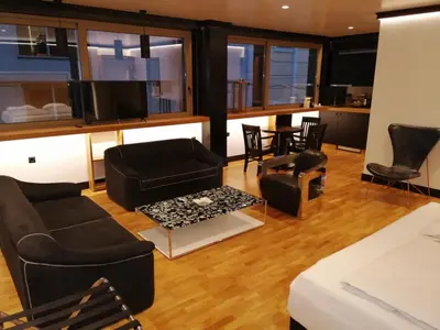a living room with black furniture and a table at Andromeda Downtown Residence in Athens