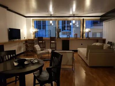 a living room with a couch and a table at Andromeda Downtown Residence in Athens