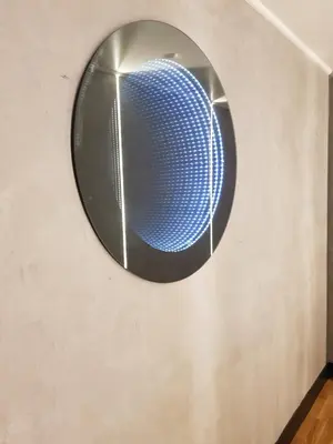 a circular mirror on the wall of a room at Andromeda Downtown Residence in Athens