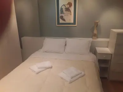 a bedroom with a bed with two towels on it at Deluxe Apartment Best Point in Athens