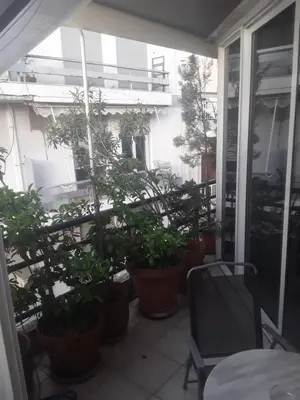 a balcony with a bunch of potted plants on it at Deluxe Apartment Best Point in Athens