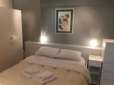 a bedroom with a bed with two towels on it at Deluxe Apartment Best Point in Athens
