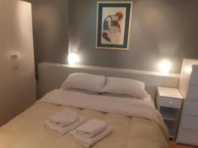 a bedroom with a bed with two towels on it at Deluxe Apartment Best Point in Athens