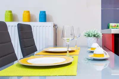 a table with two plates and glasses of wine at City Stay Alexandras Av. in Athens