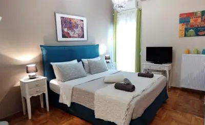 a bedroom with a large bed and a television at City Stay Alexandras Av. in Athens
