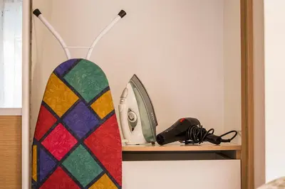 a surfboard sitting on a shelf next to a mirror at City Stay Alexandras Av. in Athens