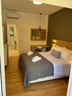 a bedroom with a bed with two towels on it at Fospitality Varkiza in Varkiza