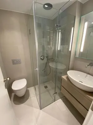 a bathroom with a shower and a toilet and a sink at Fospitality Varkiza in Varkiza