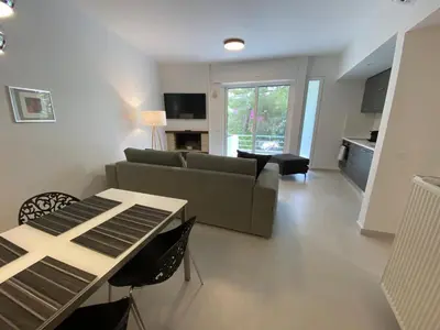a living room with a couch and a table at Fospitality Varkiza in Varkiza
