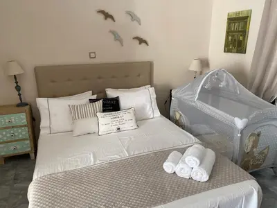 a bedroom with a bed with towels on it at Aelia Houses in Agia Marina Aegina