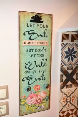 a picture hanging on a wall with a sign at Aelia Houses in Agia Marina Aegina