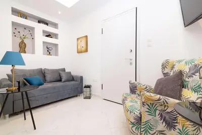 a living room with a couch and a table at Lyto by Heloni Apartments in Athens