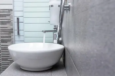 a bathroom with a white bowl sink in a stall at Lyto by Heloni Apartments in Athens