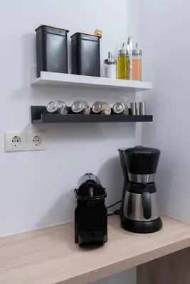 a coffee maker on a shelf with a coffee pot at Lyto by Heloni Apartments in Athens