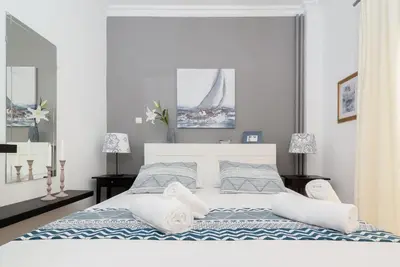 a bedroom with a large bed with towels on it at Lyto by Heloni Apartments in Athens