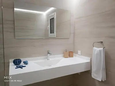 a bathroom with a white sink and a mirror at Alke Homme II in Athens