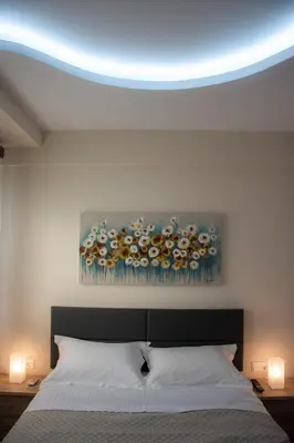 a bedroom with a bed with a blue ceiling at Alke Homme II in Athens