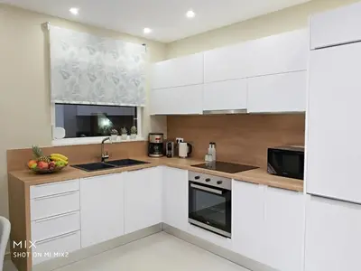 a kitchen with white cabinets and a microwave at Alke Homme II in Athens