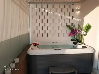 a bathroom with a tub with flowers in it at Alke Homme II in Athens