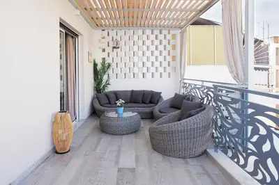 a patio with two couches and a table on a balcony at Alke Homme II in Athens