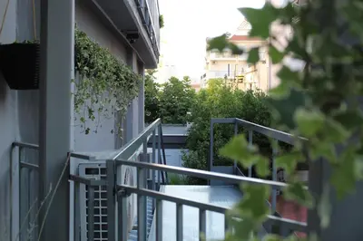 a metal railing on a balcony of a building at Luxe house in Glyfada with spa near metro station C8 in Athens