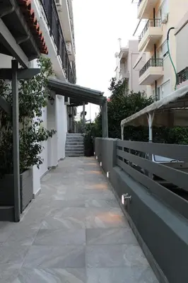 a walkway in the middle of a building at Luxe house in Glyfada with spa near metro station C8 in Athens