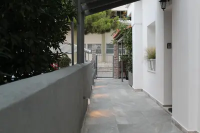 a walkway in a house with a fence at Luxe house in Glyfada with spa near metro station C8 in Athens