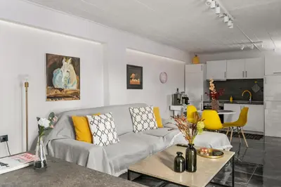 a living room with a couch and a table at Luxe house in Glyfada with spa near metro station C8 in Athens