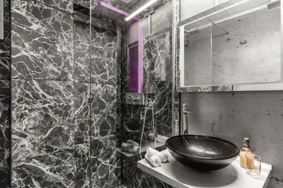 a black and white bathroom with a sink and a mirror at Luxe house in Glyfada with spa near metro station C8 in Athens