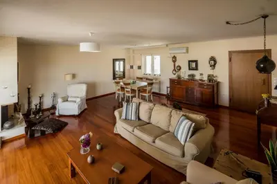 a living room with a couch and a table at Family getaway, spacious and luxurious, sea view, terrace, 5 minutes from Voula beach, 30min from Athens center in Athens