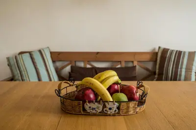 a basket of fruit sitting on a table at Family getaway, spacious and luxurious, sea view, terrace, 5 minutes from Voula beach, 30min from Athens center in Athens