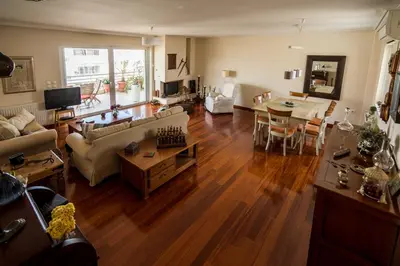 a living room with a couch and a table at Family getaway, spacious and luxurious, sea view, terrace, 5 minutes from Voula beach, 30min from Athens center in Athens