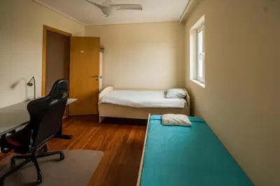 a room with a bed and a desk and a chair at Family getaway, spacious and luxurious, sea view, terrace, 5 minutes from Voula beach, 30min from Athens center in Athens