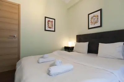a bedroom with a large white bed with towels on it at Athens City Themis 7 in Athens