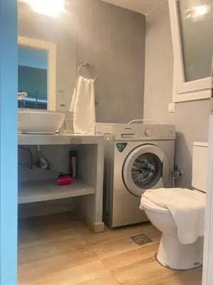 a bathroom with a washing machine and a sink at Athens City Themis 7 in Athens