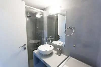a bathroom with a white sink and a mirror at Athens City Themis 7 in Athens