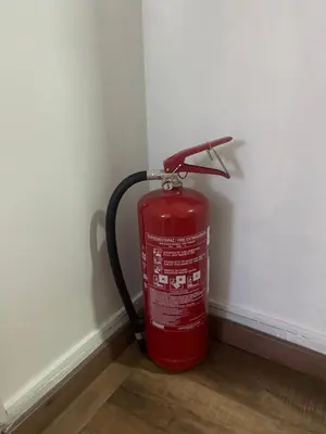 a red fire hydrant sitting in the corner of a wall at Athens City Themis 7 in Athens