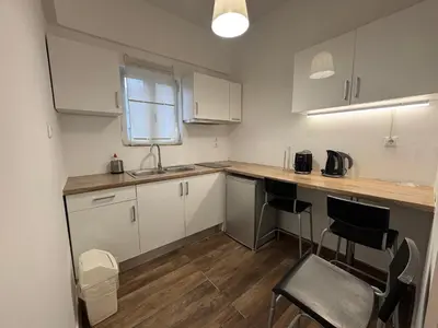 a kitchen with white cabinets and a counter top at Athens City Themis 7 in Athens