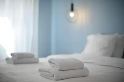 two stacks of towels sitting on a bed at 3 mins walking from Acropolis in Athens