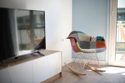 a chair in a living room with a television at 3 mins walking from Acropolis in Athens