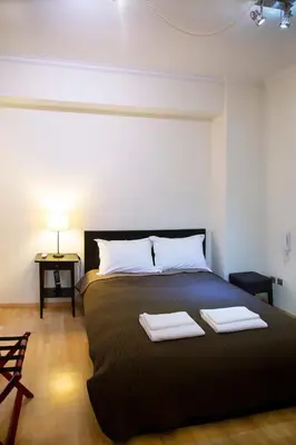 a bedroom with a bed with two towels on it at Athens Best location, 6 Ermou street, Syntagma square in Athens