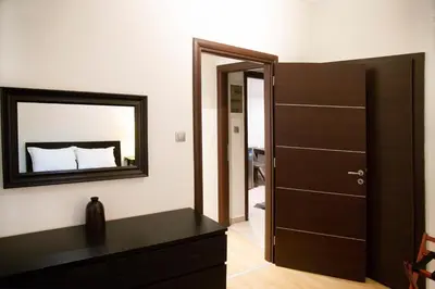 a bedroom with a mirror and a black dresser at Athens Best location, 6 Ermou street, Syntagma square in Athens
